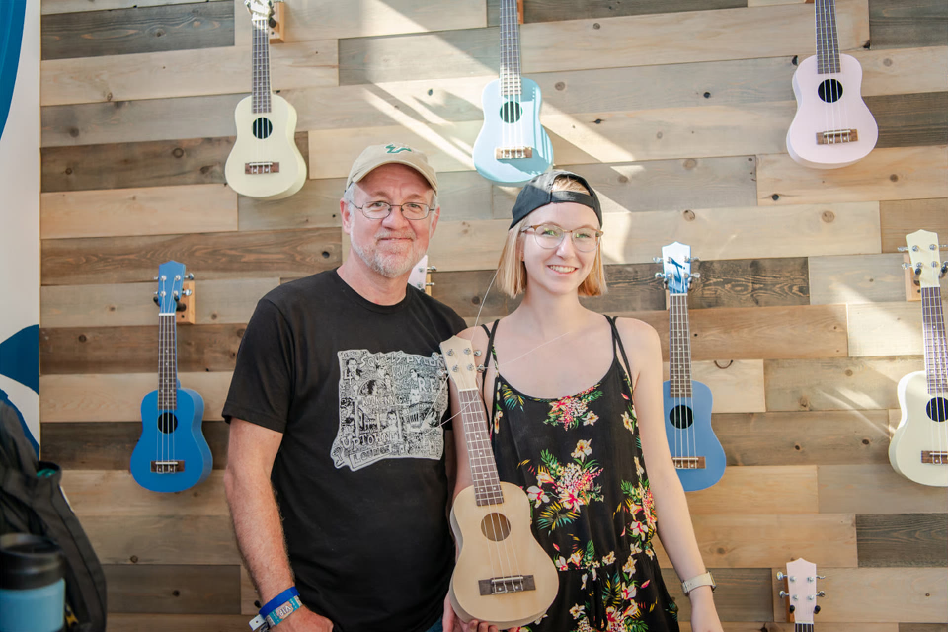 A father and daughter with a ukulele from the music education wall